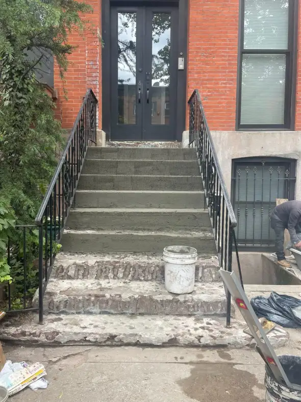 Base coat going on the upper treads at 233 Bergen Street — combed, keyed texture; lower treads still raw