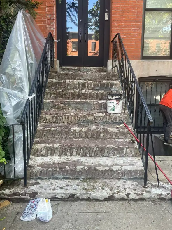 The stoop at 233 Bergen Street before resurfacing — finish coat failed, peeling and spalling on every step