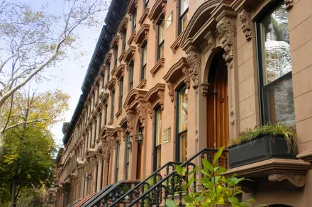 Restored brownstone facade detail — carved lintels and stoop (brwnstne_rwhse.jpg)