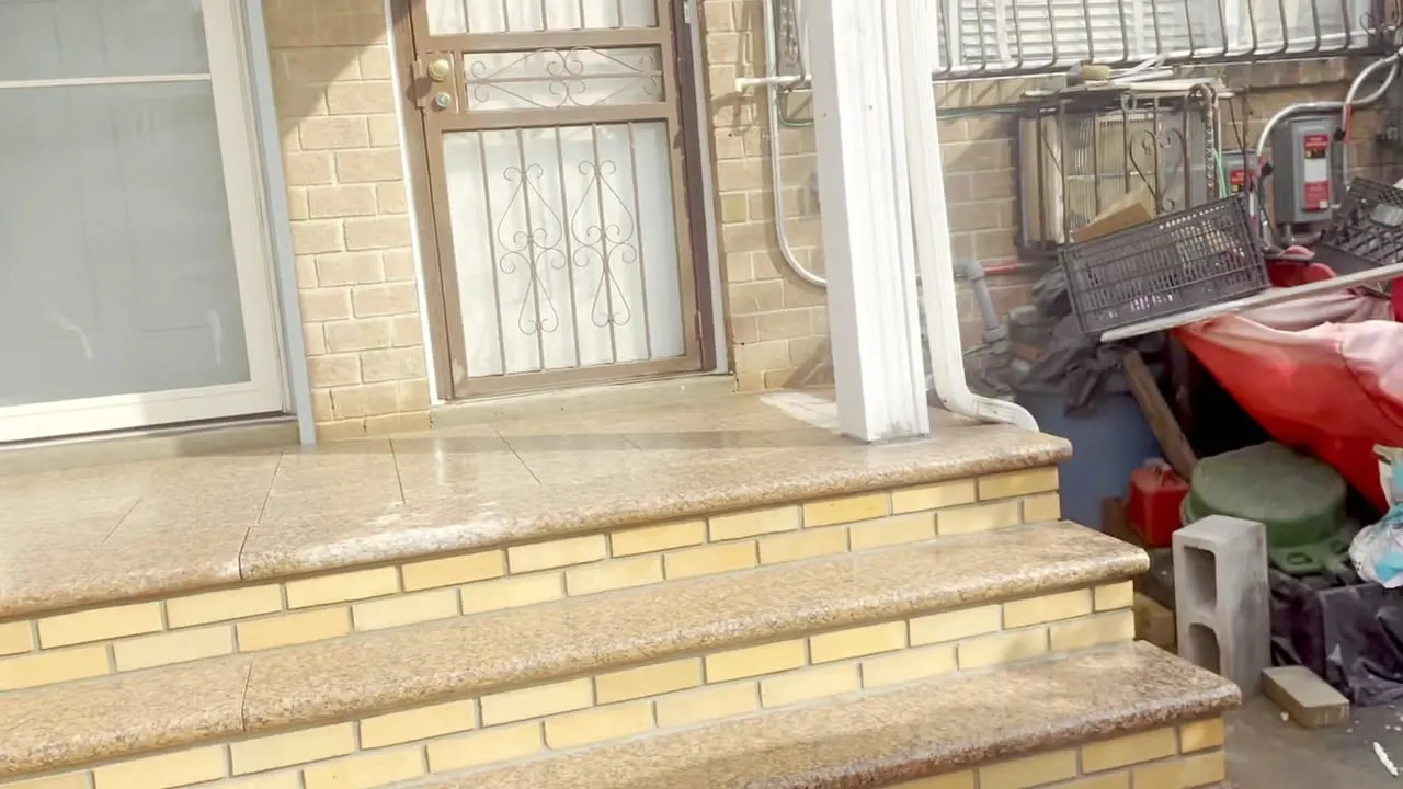 The new brick steps at 148 George Street, Brooklyn — buff-brick risers, polished granite treads, granite porch landing