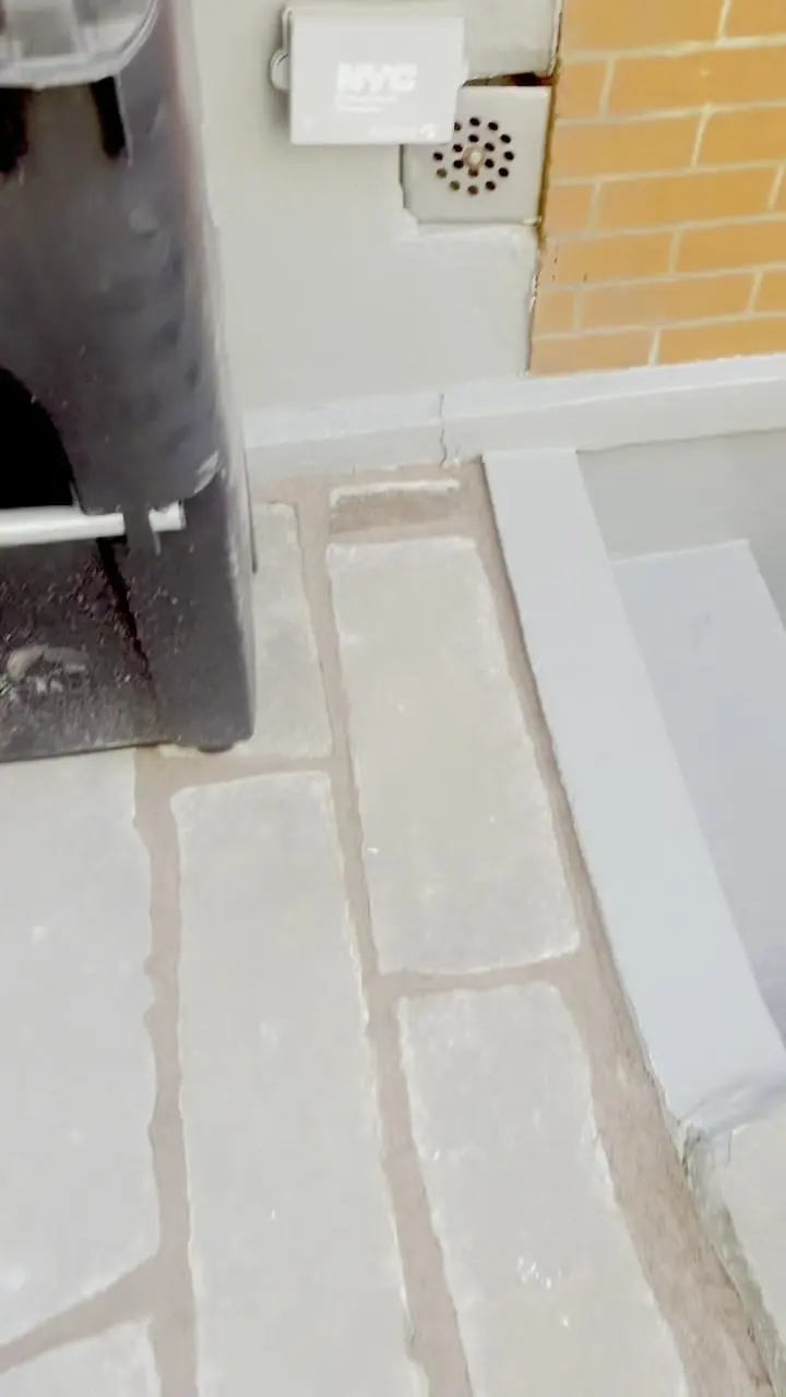 Below the stoop at 274 Hoyt Street — the areaway wall and stone-paver front path