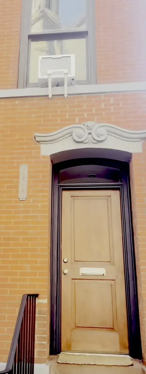 The renewed carved door header — scrollwork lintel — over the entry at 274 Hoyt Street