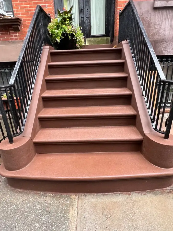 The restored brownstone stoop at 31 South Oxford Street, Brooklyn — smooth brownstone finish